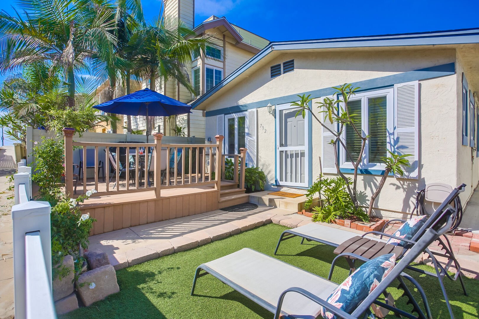 Private front yard space with lounge chairs, dining table for 4-6 guests, large umbrella, BBQ and beach access