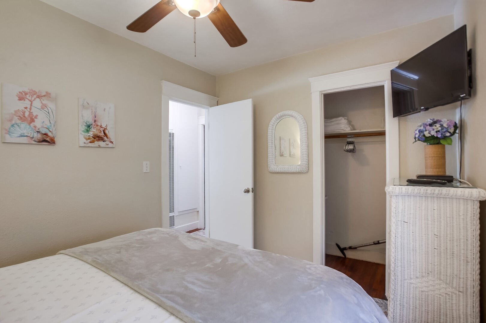 Master bedroom with closet and dresser storage and ceiling fan