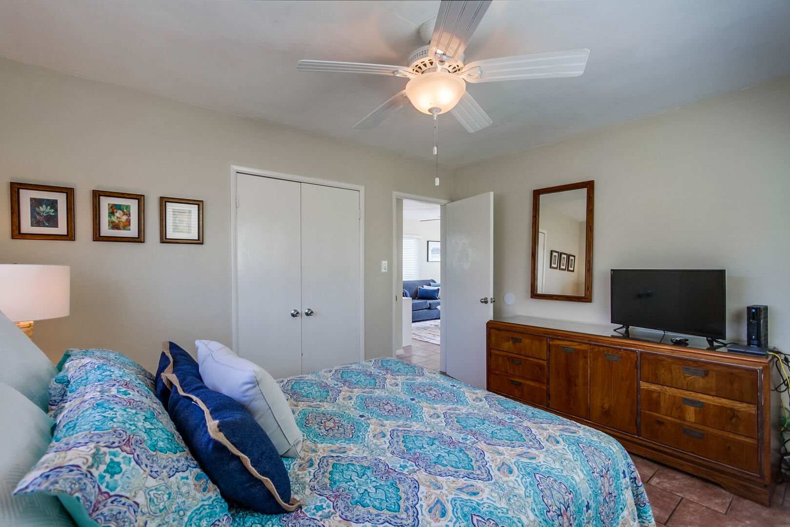 Guest bedroom has ample closet and dresser space, TV and warm sunshine