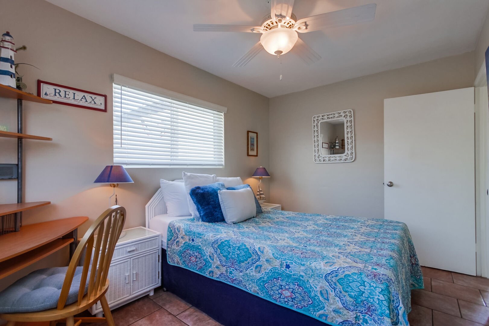 Second guest bedroom with queen size bed, ceiling fan, closet storage and desk to work from the beach!
