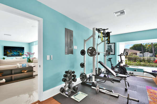 Home gym has a Peloton Bike, Pull up / squat rack, free weights, space for your yoga mat, a lovely view and is close to the living room in case you need to keep an eye on the children!