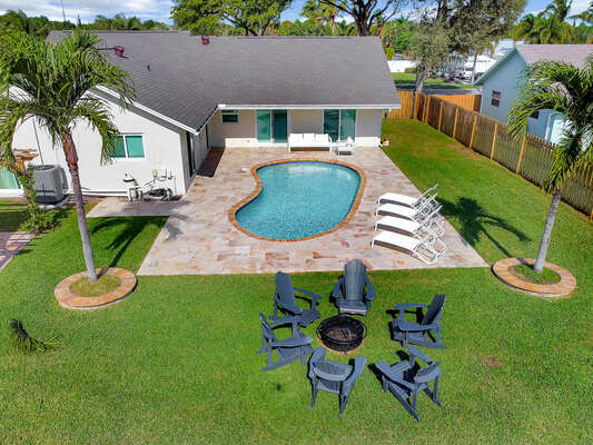 Private fenced yard with lawn, heated pool, sun loungers, fire pit and BBQ, and more!