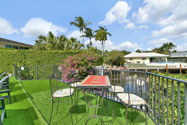 Idyllic seating area over looking the intracostal at the bottom of this private, tranquil yard
