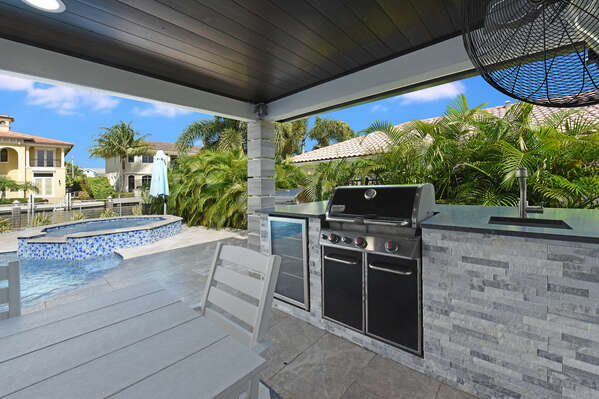 Quintessential Florida covered Lanai with built in BBQ grill, fridge and seating, all undercover for your comfort.