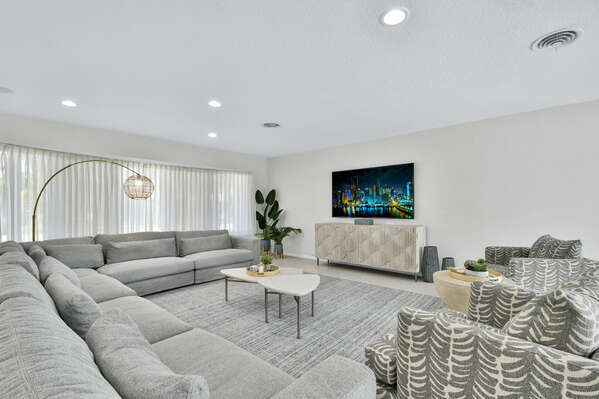 Large living area is open plan and has modern furnishings