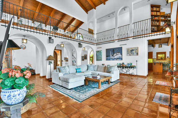 Interior of this home boasts high ceilings, exposed beams, tiled floors and large windows combine to create a unique living experience.