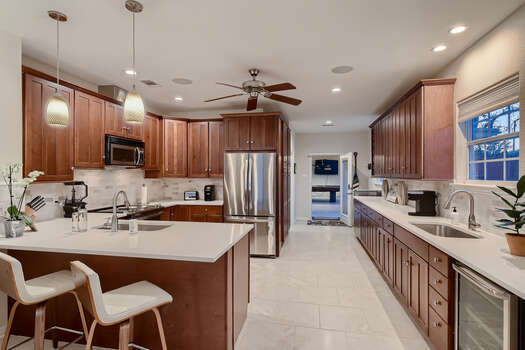 Expansive Kitchen with Plenty of Counter Space, Bar Seating and Two Sinks
