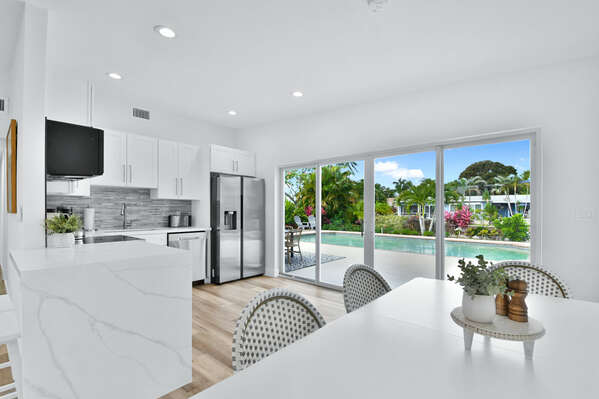 Kitchen is open plan with view of the pool
