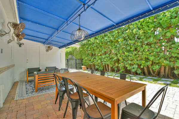 Outdoor seating area with fans and lighting, ideal or a family game or celebtration