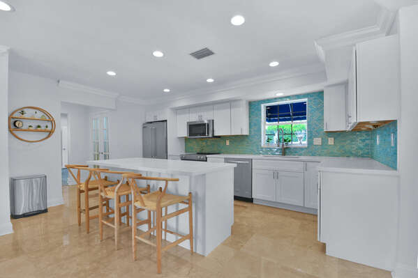 Open plan kitchen with modern fittings and utensils provided.