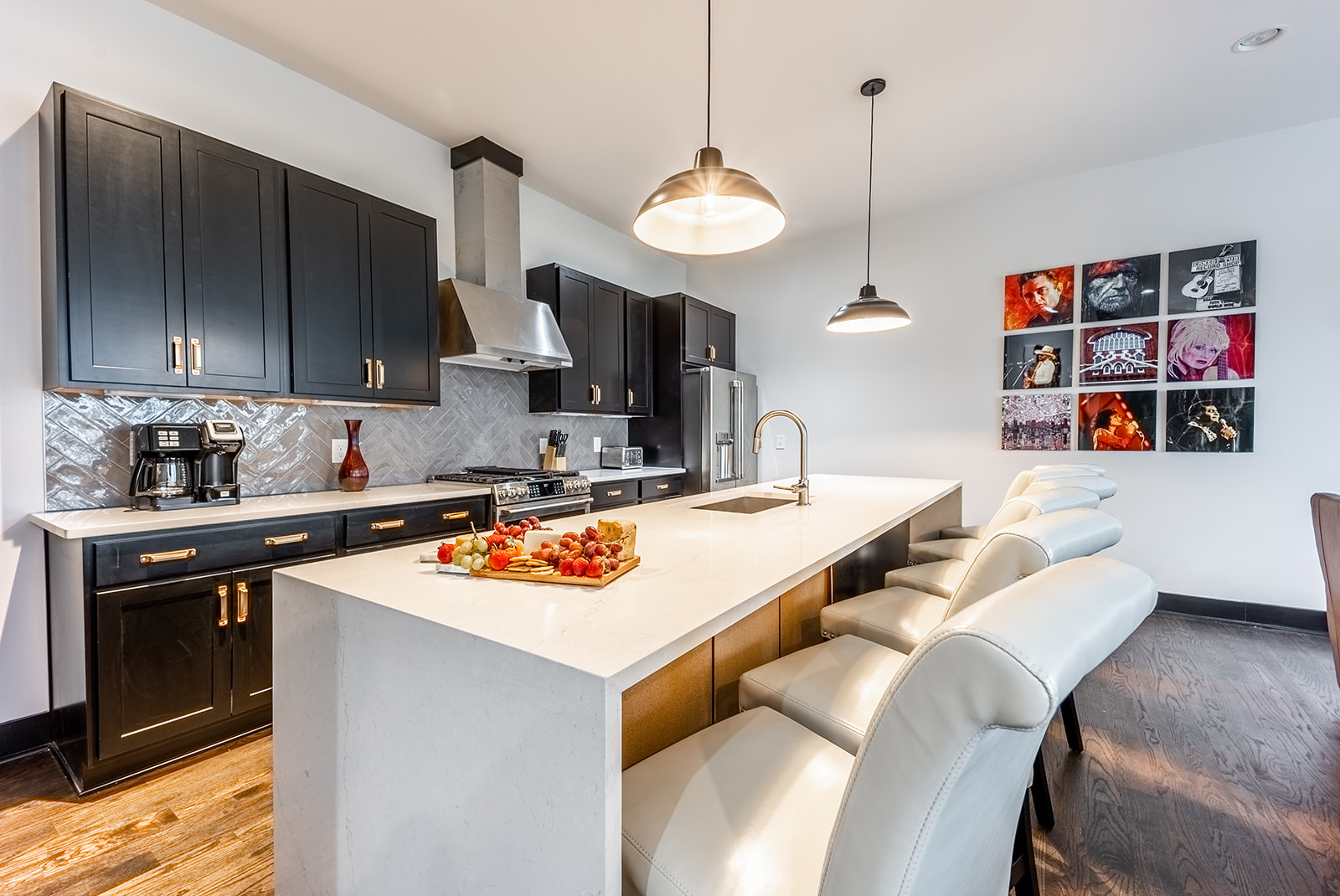 Unit 1: Fully equipped Kitchen with stainless steel appliances and breakfast bar seating.