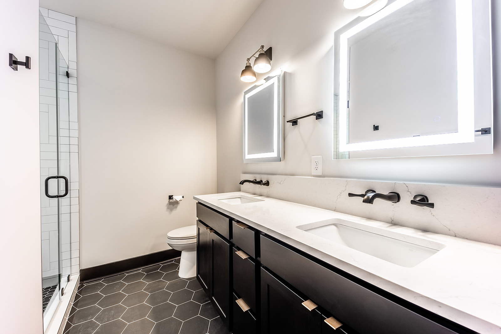 Unit 1: 2nd bathroom with dual vanity, LED mirrors, and walk in shower.