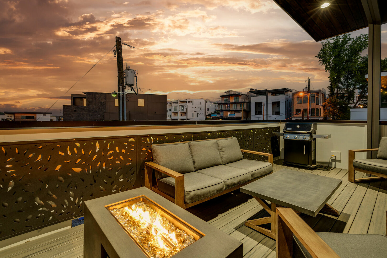 Unit 3: Rooftop balcony with outdoor BBQ, smart TV, fire pit, and seating.