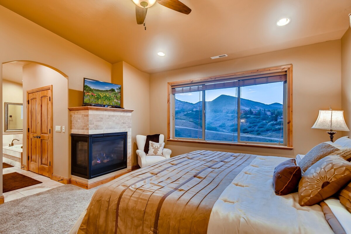 Upper Level Master Bedroom with king bed, TV, gas fireplace, and en suite bathroom