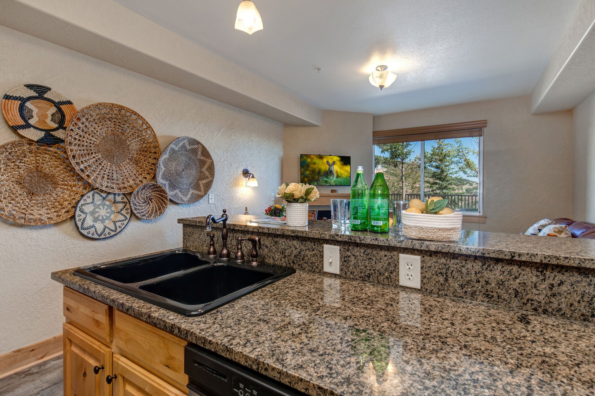 Fully Equipped Kitchen with beautiful stone countertops, stainless steel appliances, ice maker, and bar seating for 3