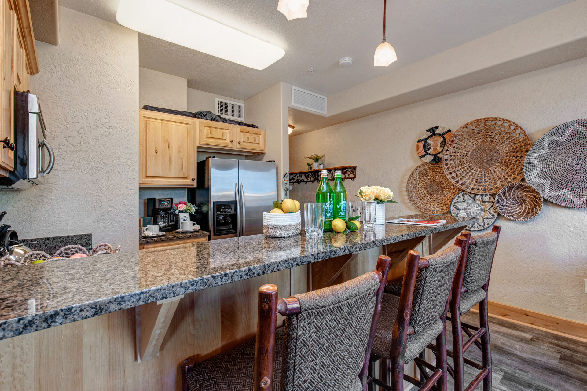 Fully Equipped Kitchen with beautiful stone countertops, stainless steel appliances, ice maker, and bar seating for 3