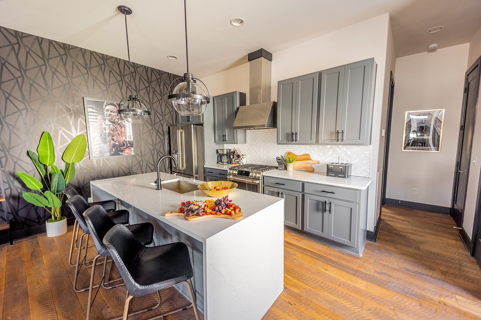 Bright open kitchen with professional stainless steel appliances and modern furnishes.