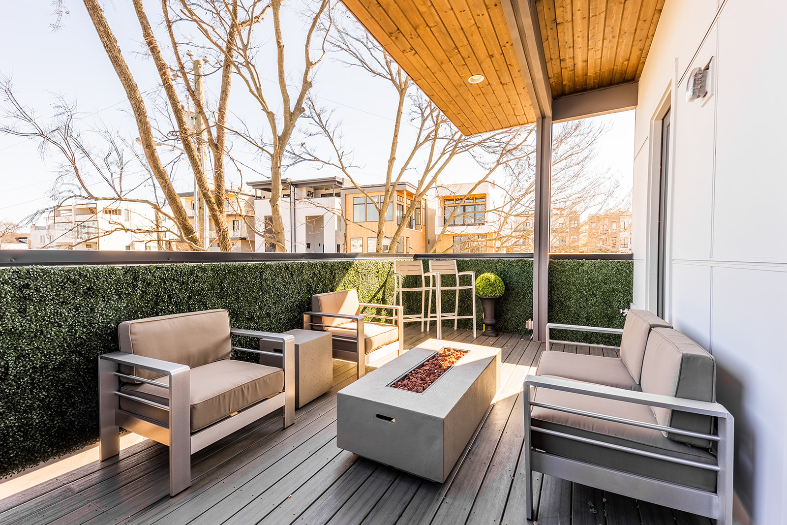 Private rooftop patio with outdoor dining, fire pit, and surrounding seating.