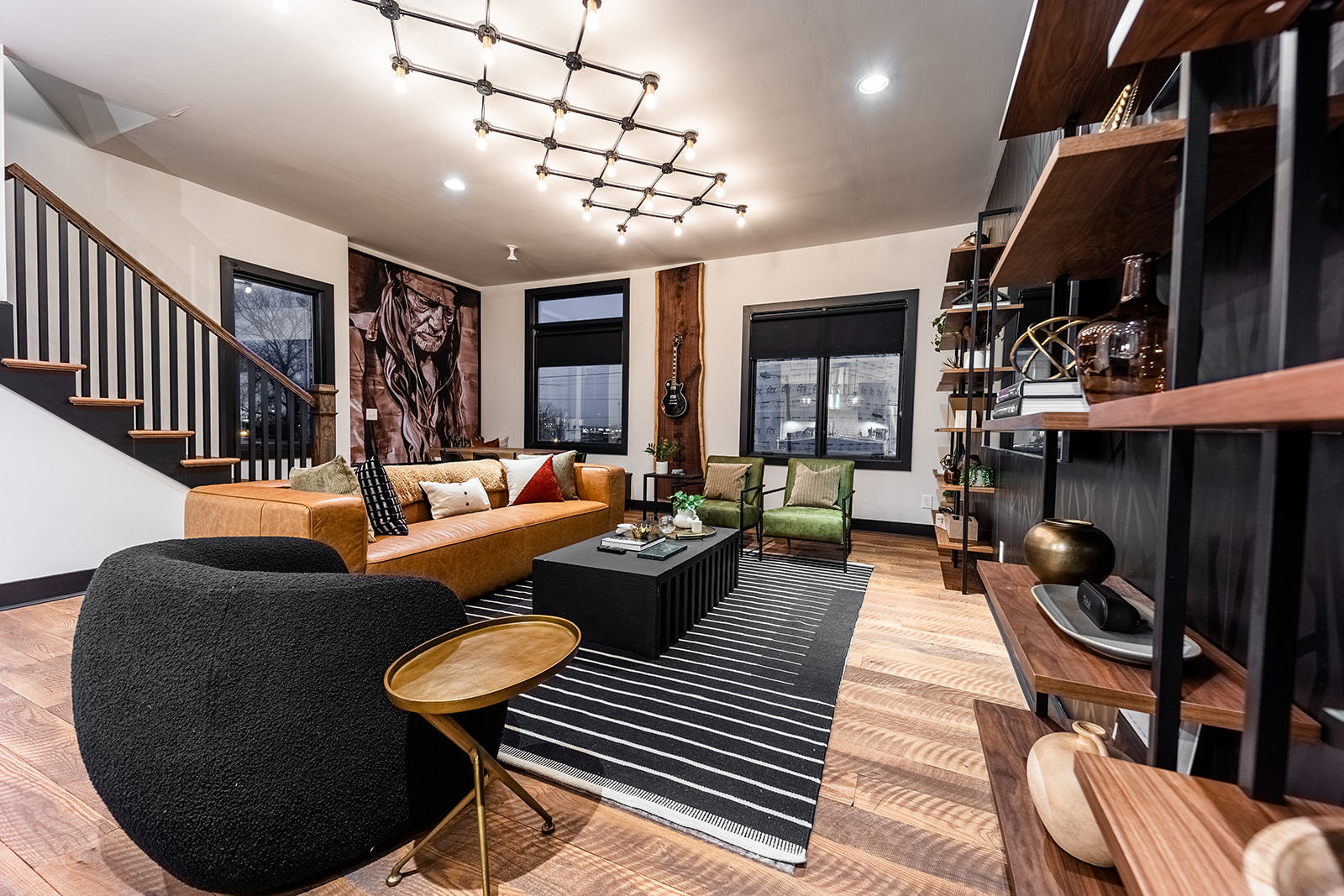 Extremely detailed spacious living area with designer luxury furnishings, 85 in flat screen TV, flooring from a 150 year old barn, custom murals/wall art, light fixtures and wall paper.