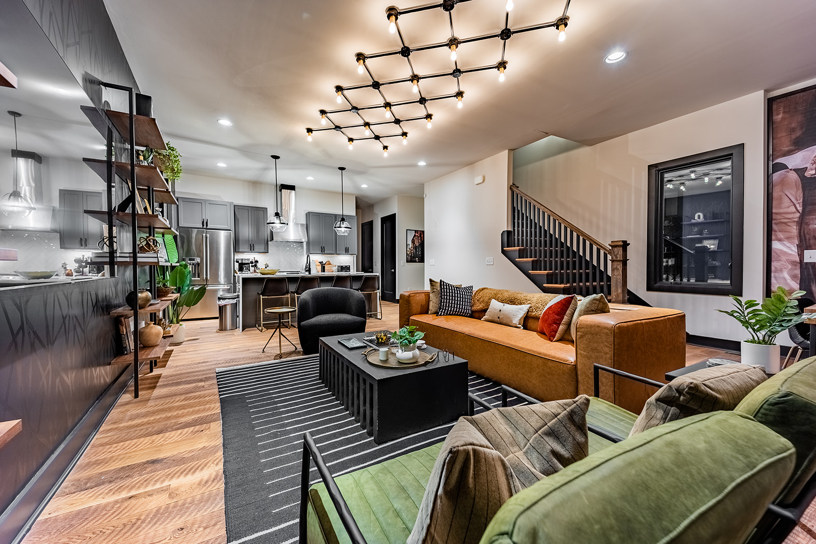 Extremely detailed spacious living area with designer luxury furnishings, 85 in flat screen TV, flooring from a 150 year old barn, custom murals/wall art, light fixtures and wall paper.