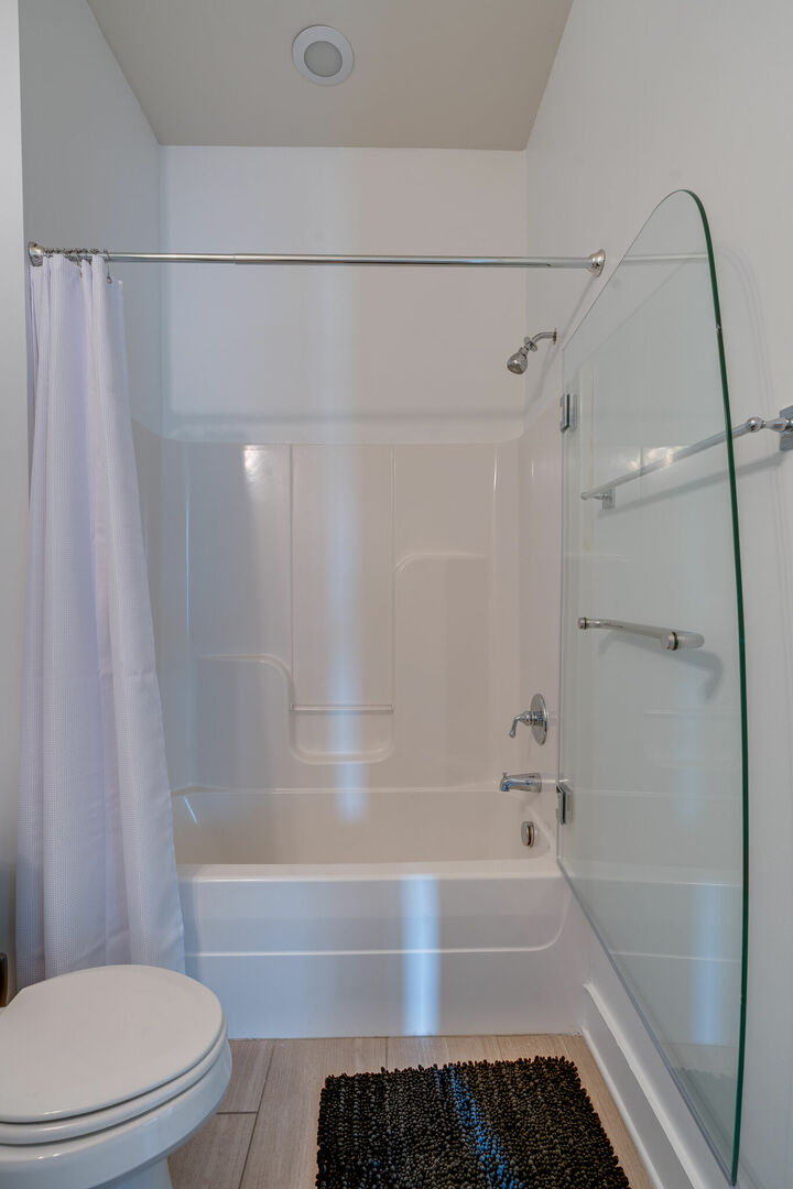 Bathroom with a shower and tub combo.
