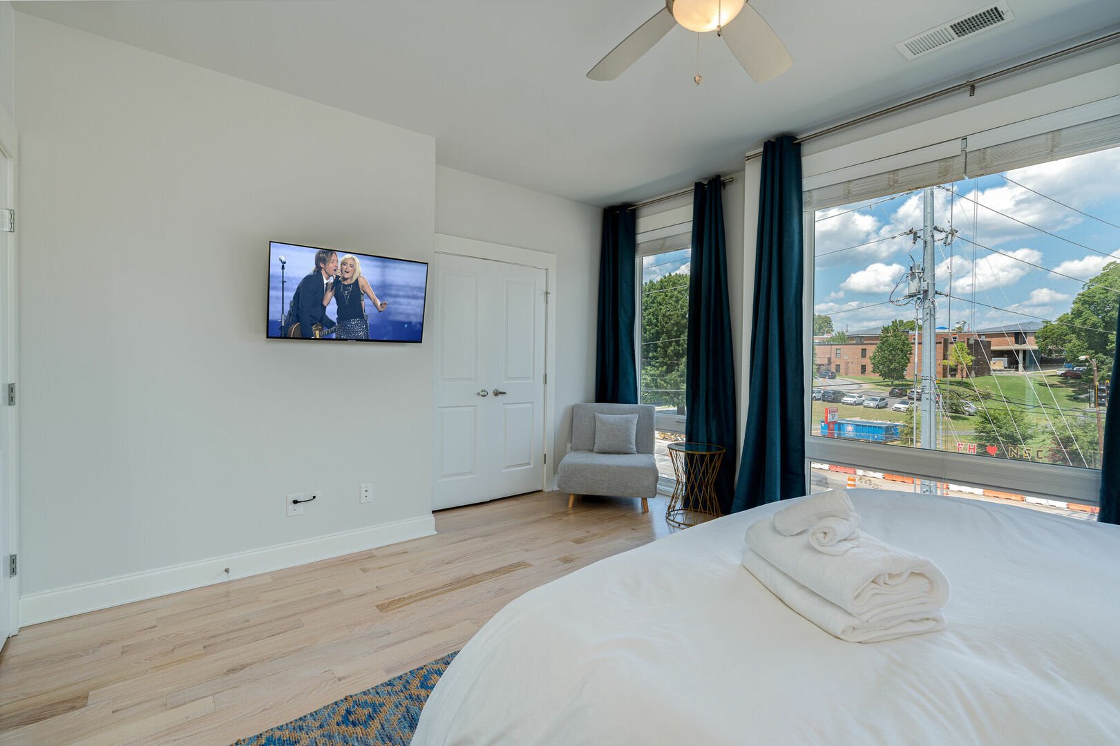 Primary bedroom with King bed, floor to ceiling windows, and en-suite bathroom.