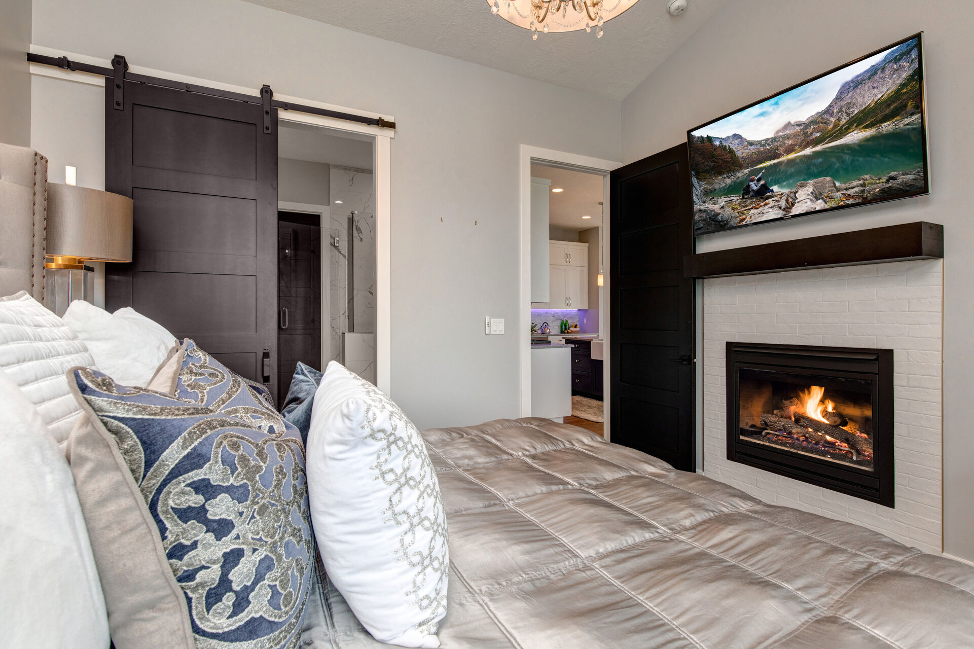 Main Level Master Bedroom with king bed, smart tv, gas fireplace, and en suite bathroom
