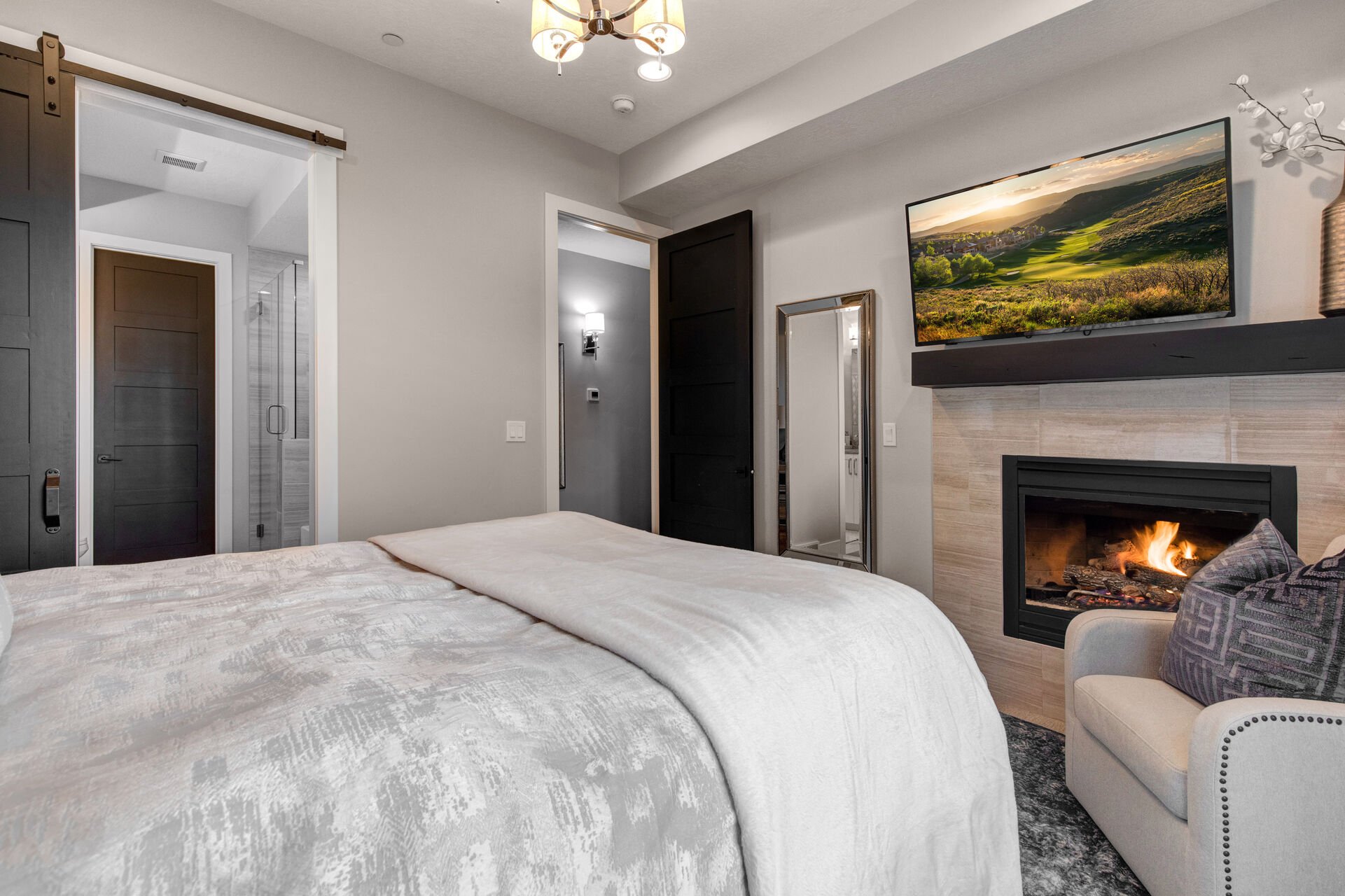 Lower Level Bedroom 2 with queen bed, smart TV, gas fireplace, and en suite bathroom