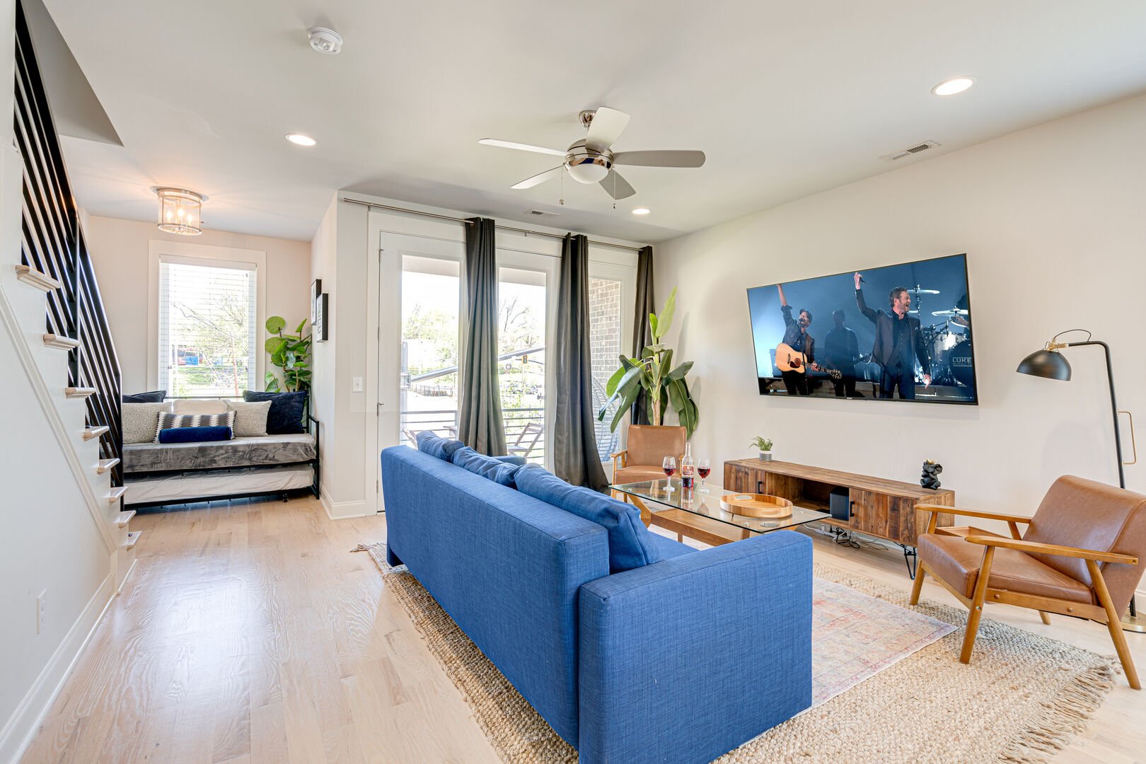 Bright and open living space with designer furnishings and smart TV.