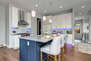 Fully Equipped Kitchen with gorgeous stone countertops, stainless steel Viking appliances, and island seating for three