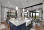 Fully Equipped Kitchen with gorgeous stone countertops, stainless steel Viking appliances, and island seating for three