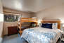 Bedroom 4 with queen bed, twin over twin bunkbed, and en suite bathroom
