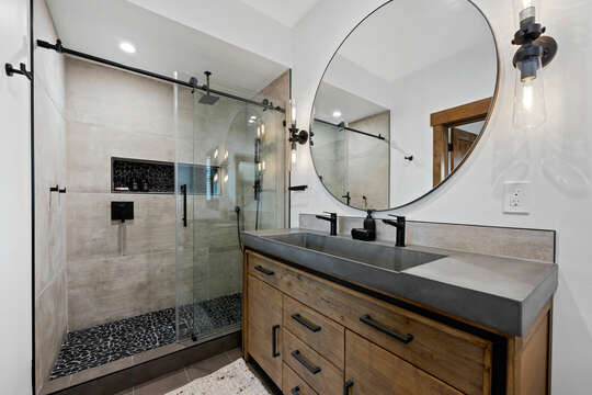 Upstairs en-suite bath offers a custom designed vanity and large shower