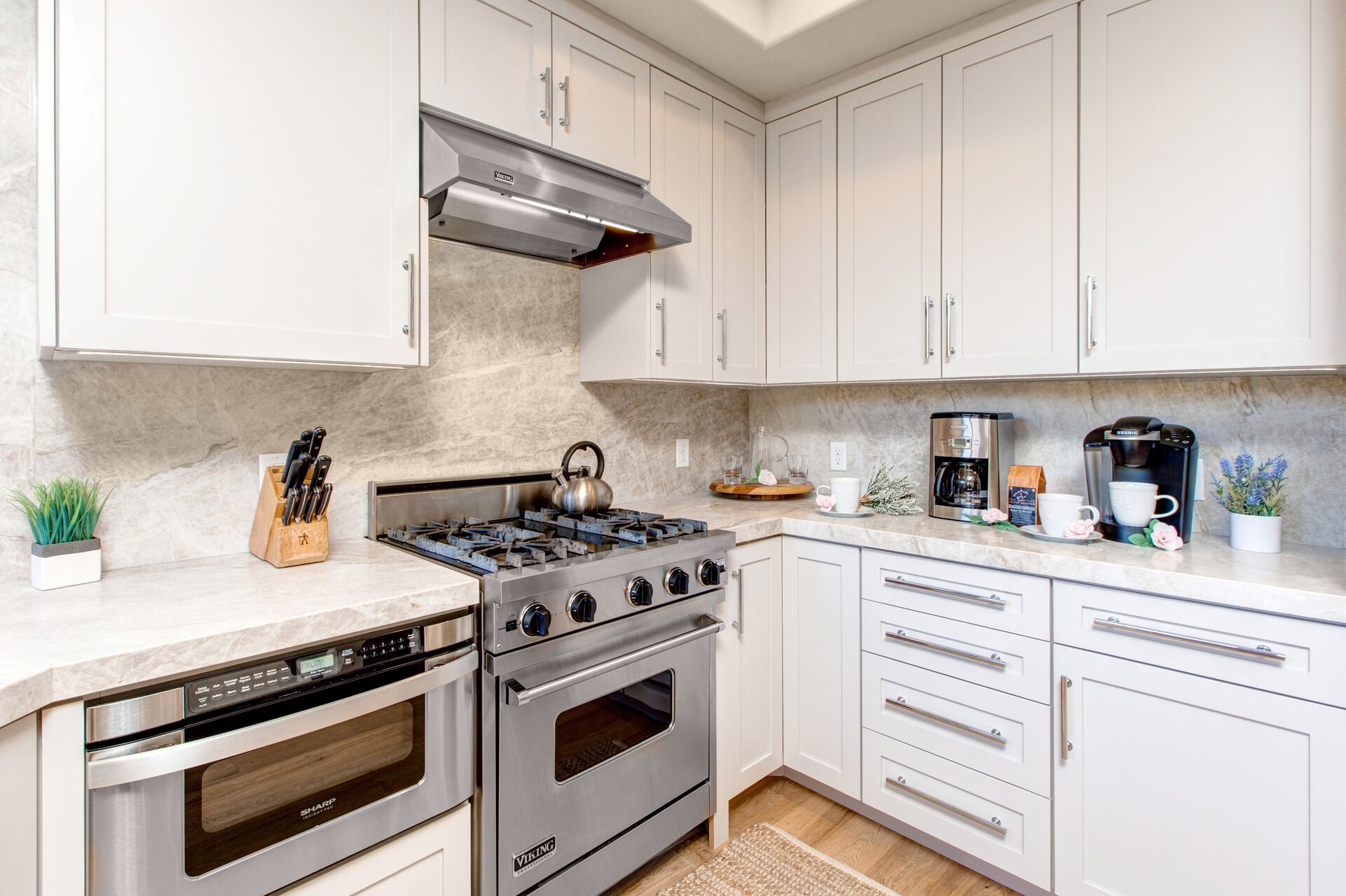 Fully Equipped Kitchen with stunning stone countertops, stainless steel Viking appliances, ice maker, and bar seating for four