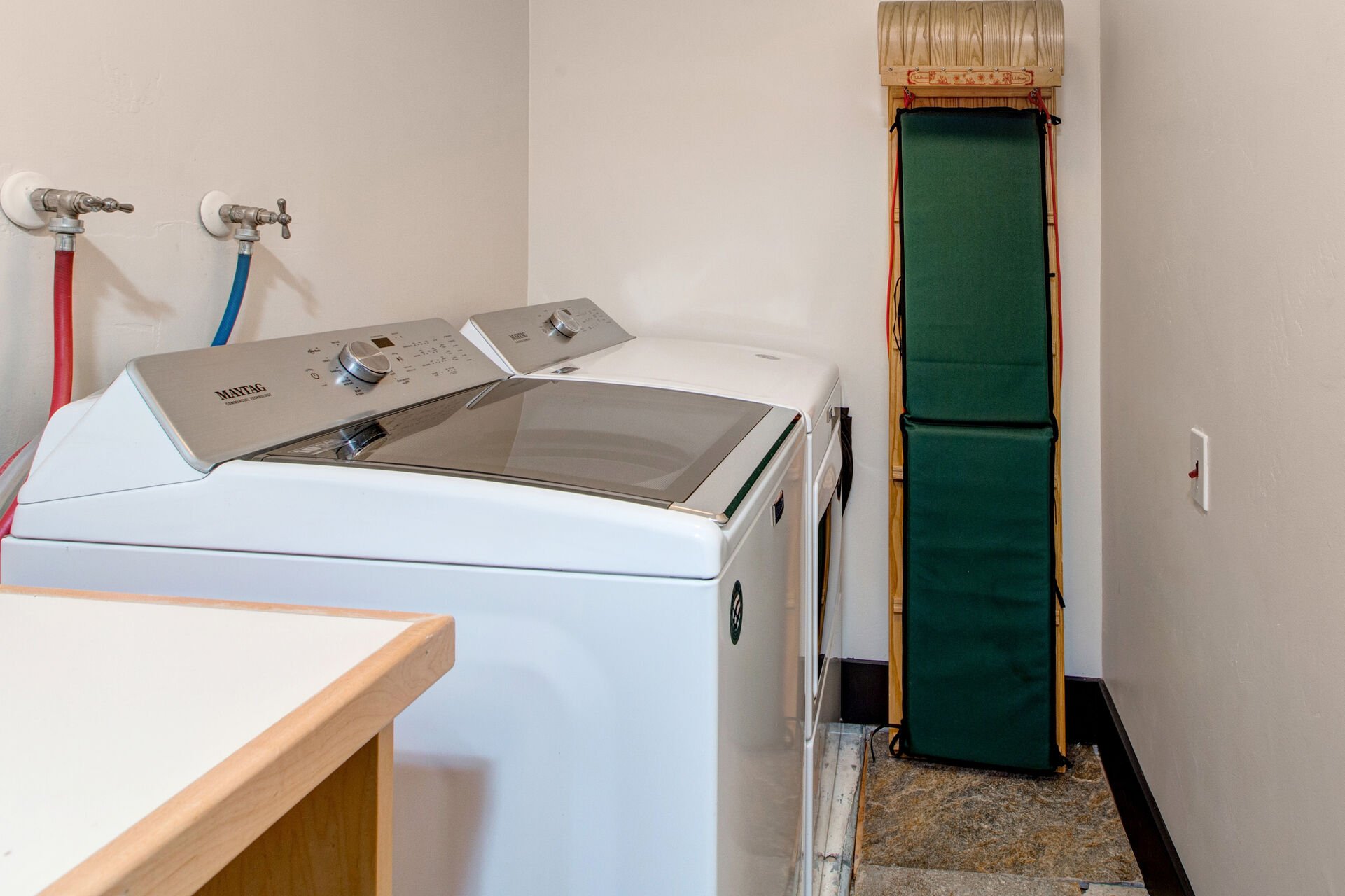 Full sized laundry room with utility sink and washer and dryer units
