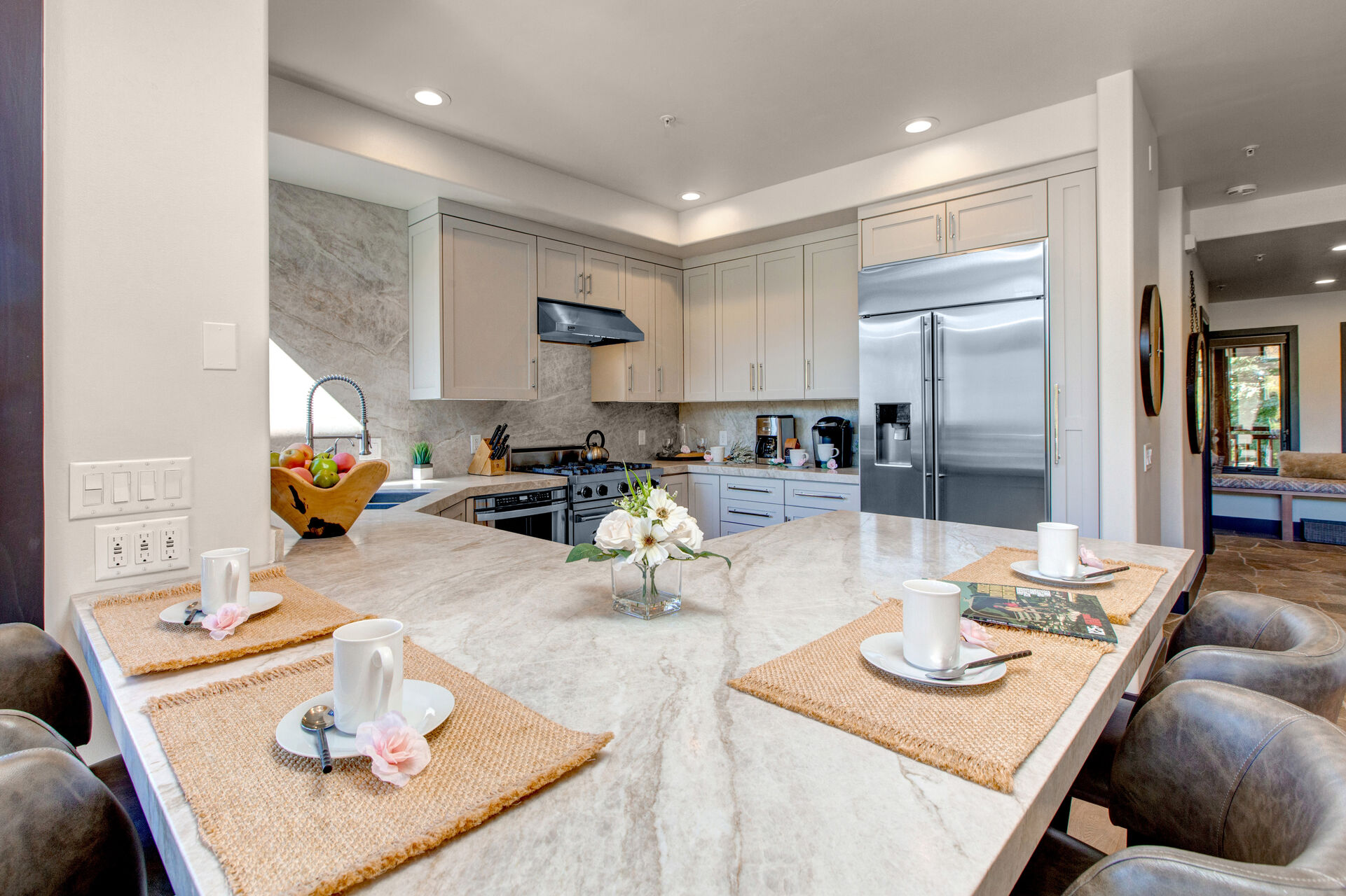 Fully Equipped Kitchen with stunning stone countertops, stainless steel Viking appliances, ice maker, and bar seating for four