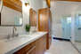 Master Bathroom with double sinks, large soaking tub, and oversized tile and glass shower