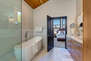 Master Bathroom with double sinks, large soaking tub, and oversized tile and glass shower