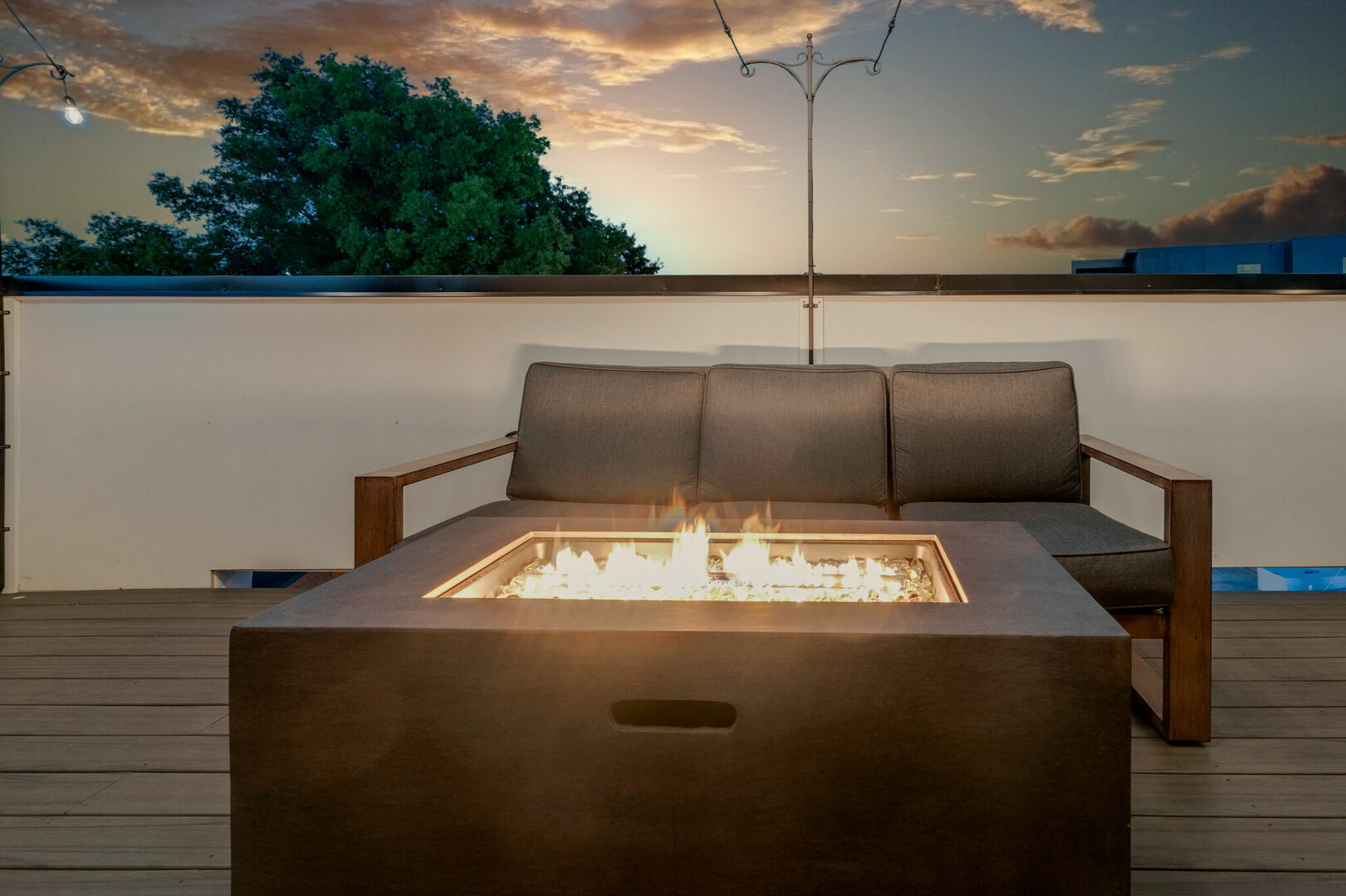 2nd unit: Rooftop patio with fire pit, outdoor bbq grill and lounge area draped in bistro lights.