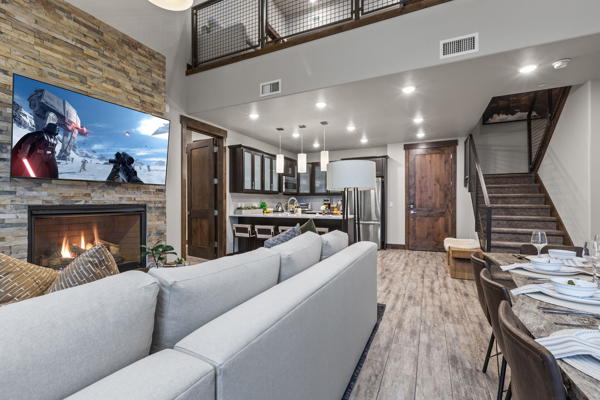 Contemporary furniture including a sectional sofa with sofa sleeper, a Smart TV, and a cozy gas fireplace. Step out onto the adjacent deck and you will also find outdoor furnishings and a BBQ grill.