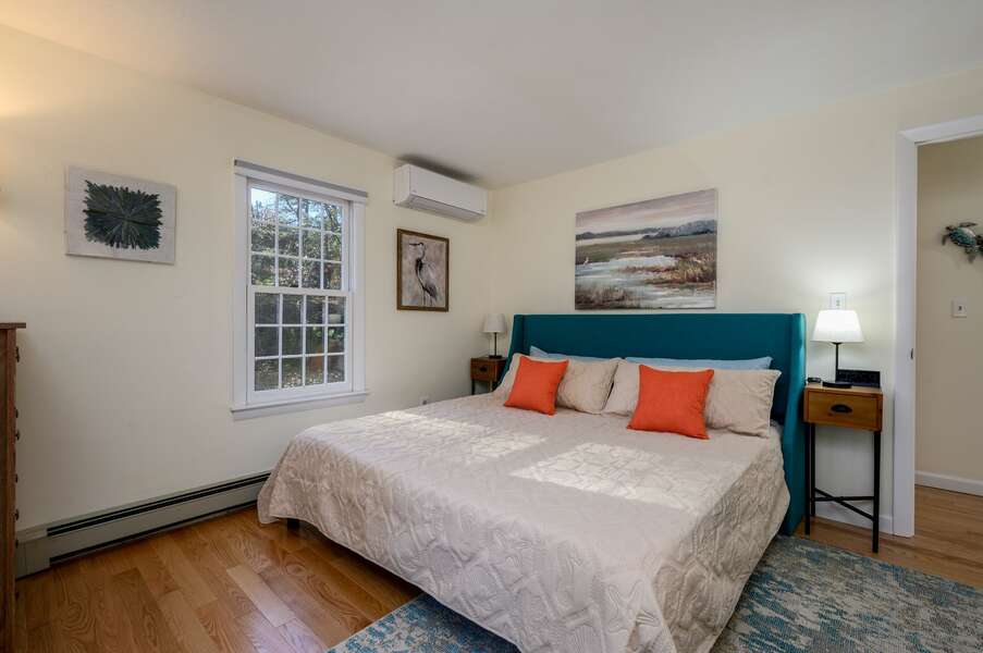 First floor King bedroom with soothing hues of ocean blue and beach life artwork - 1325 Bridge Road Eastham Cape Cod