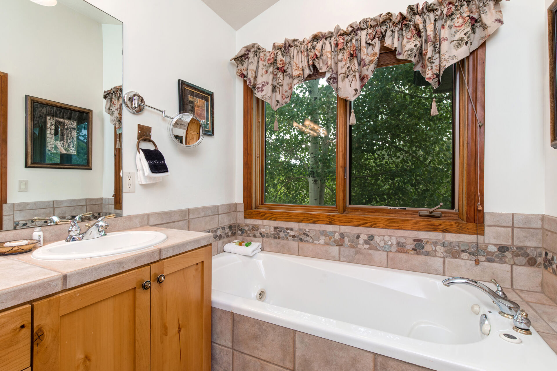 Master Bathroom with double vanities, jetted tub, and glass & tile shower