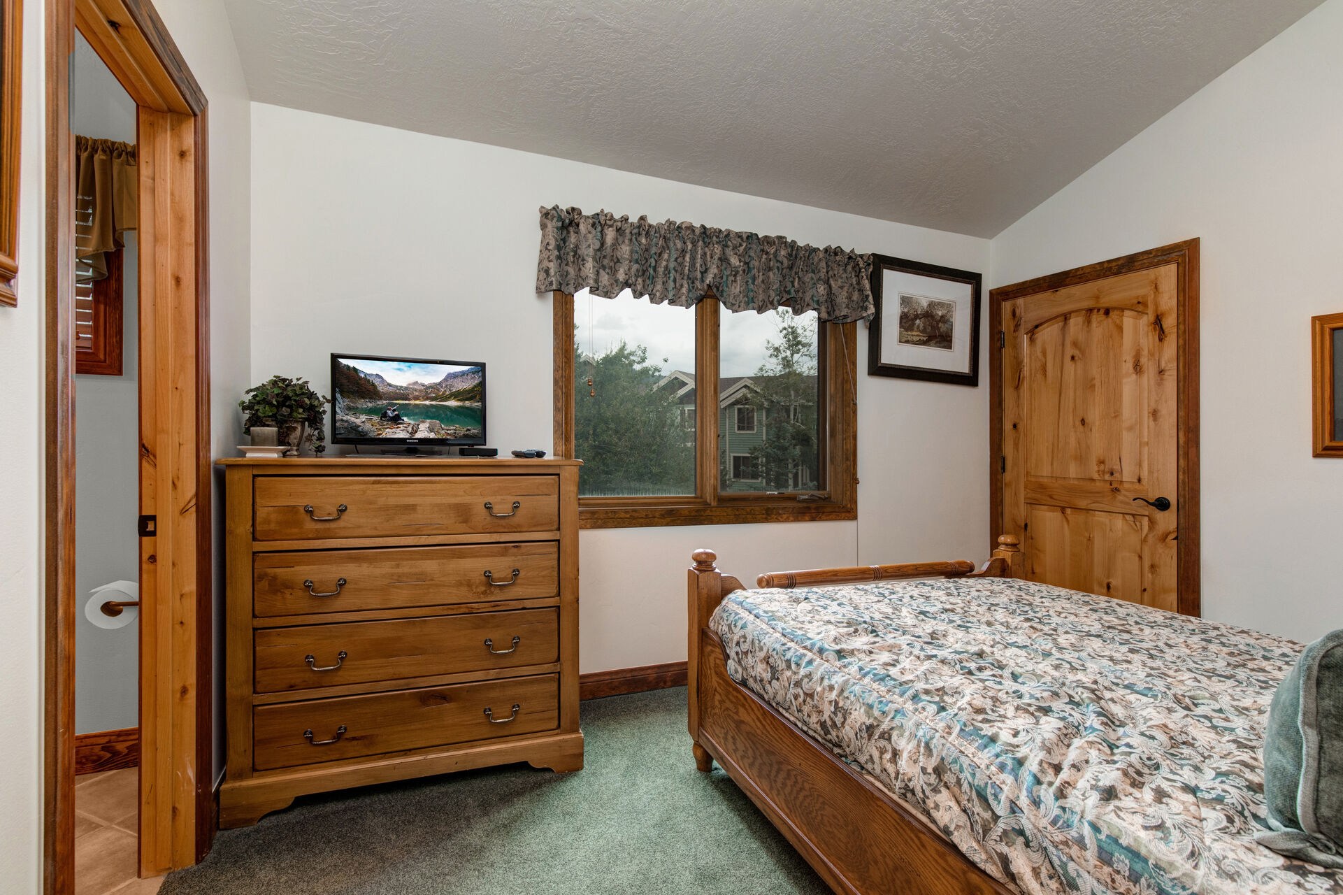 Bedroom 3 with full bed, TV, and en suite bathroom