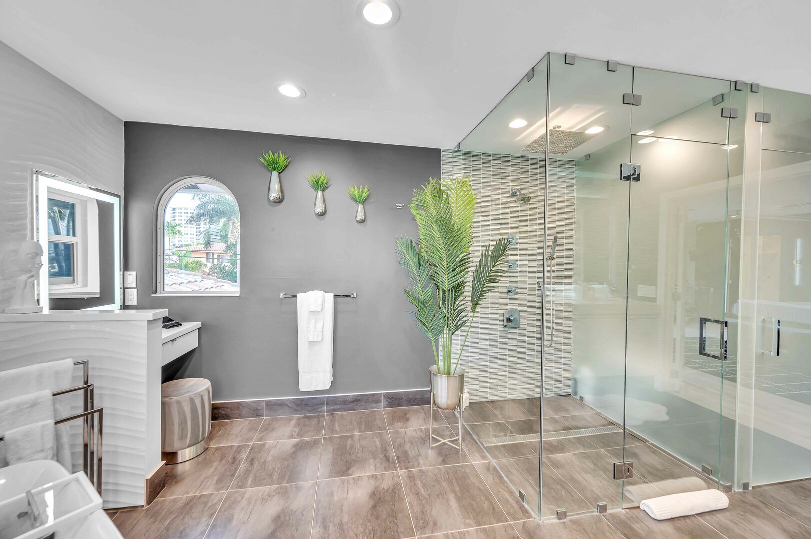 Primary Bathroom with two sinks, soaking tub, a vanity and a walk-in shower.