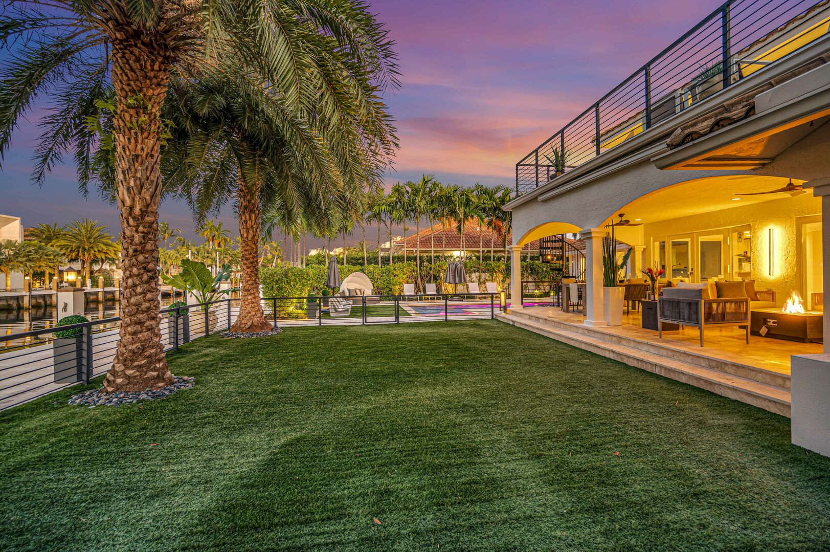 Relish in waterfront tranquility from the back yard with its dining and lounge areas.