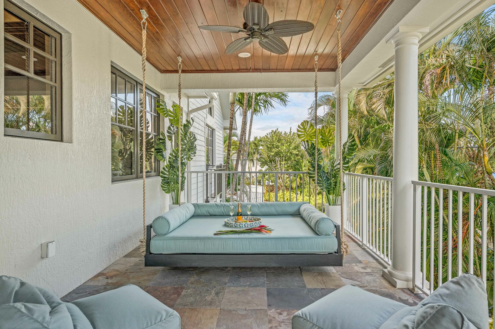 The veranda overlooks the heated pool and has its own private queen hanging bed by Nate and Lane.