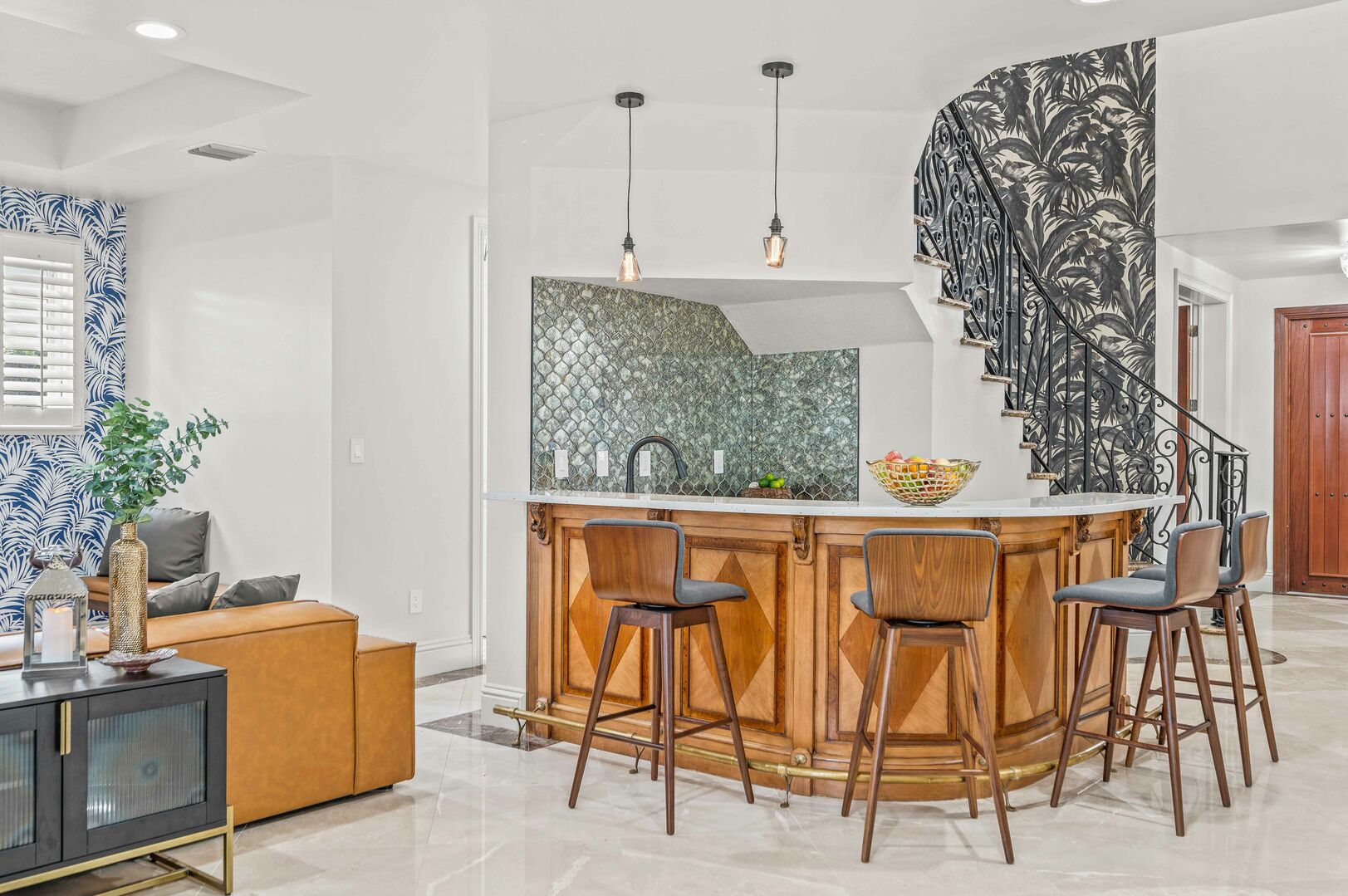 The wet bar with the adorned with Versace wallpaper as background seats four.