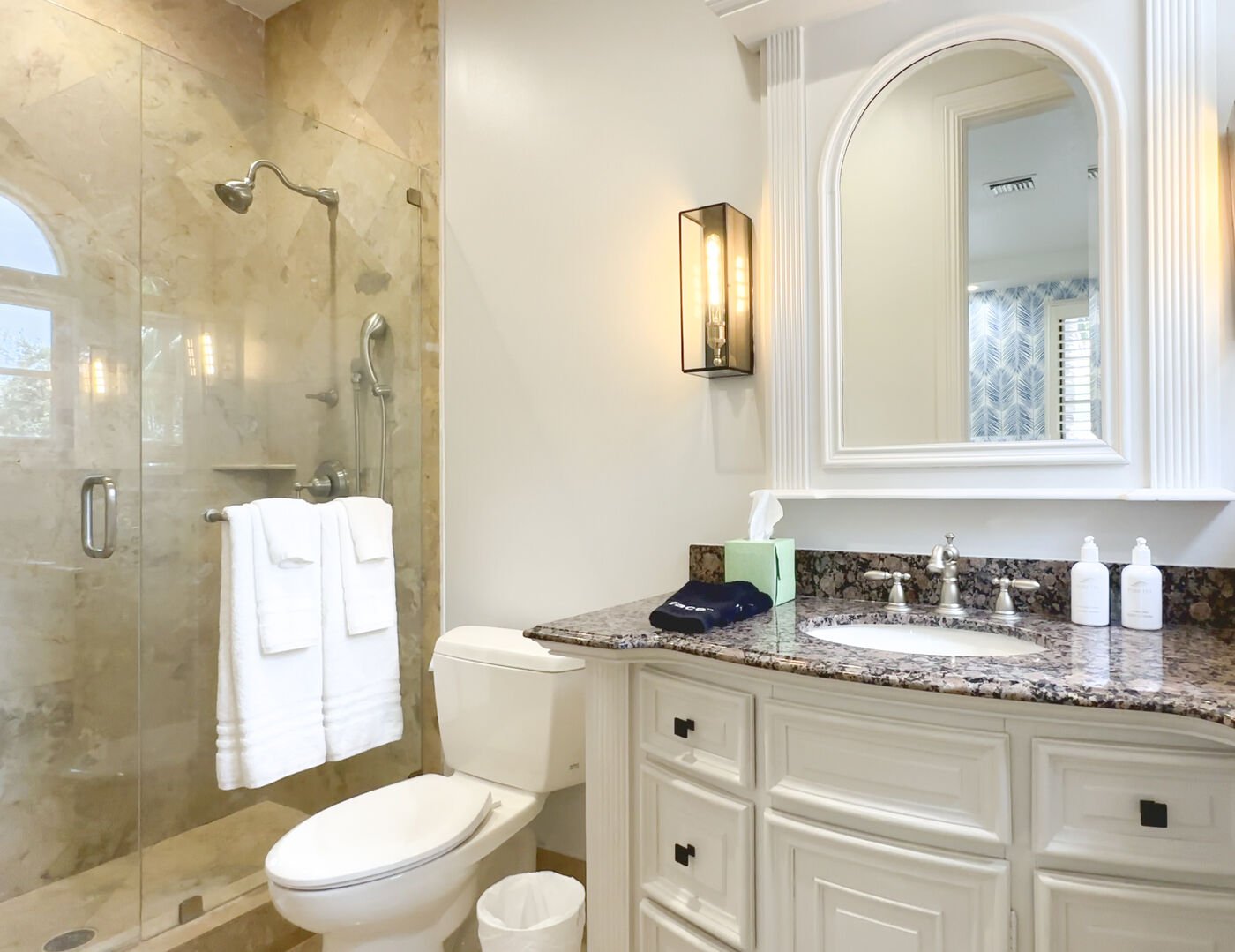 The blue palm bedroom features a bathroom with a walk in shower.