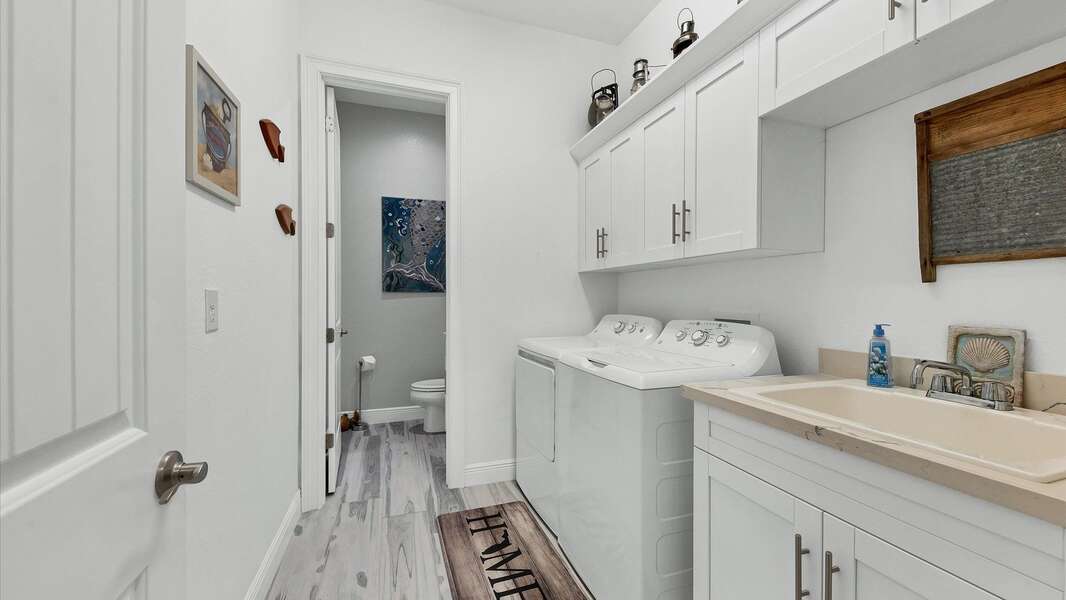 Spacious laundry room with full size washer and dryer