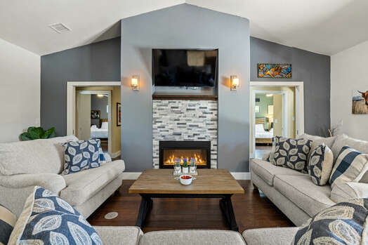 Comfortable Living Room with a See-Through Gas Fireplace and Smart TV